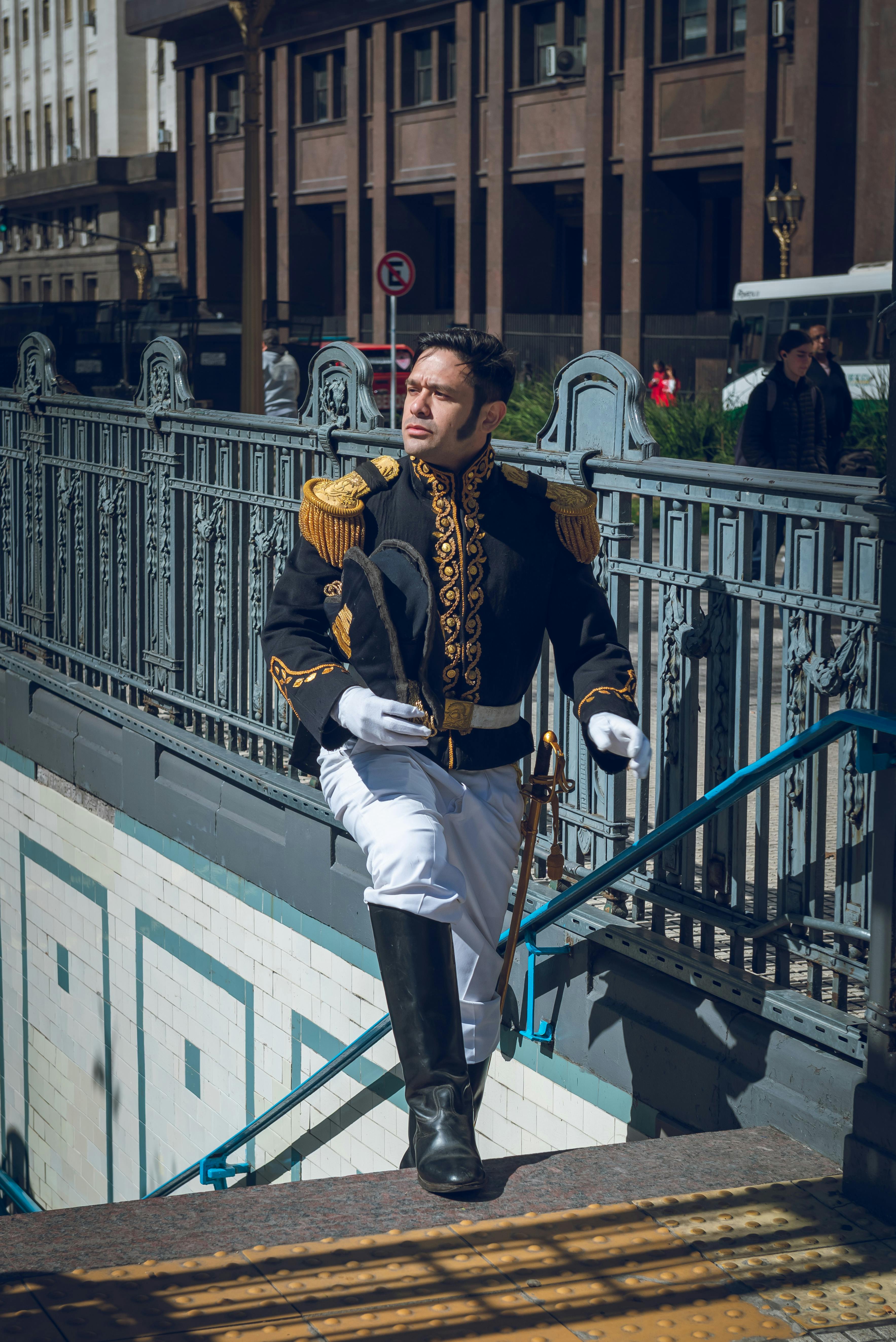 A man in historical military garb ascending stairs in downtown Buenos Aires.