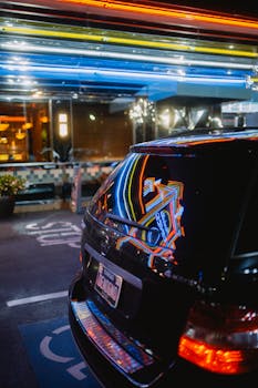 Vibrant neon reflections on a car at Marietta's iconic retro diner during the night.