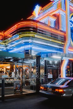 Cinematic night scene of a vibrant retro diner with colorful neon lights and reflections in Marietta, Georgia.