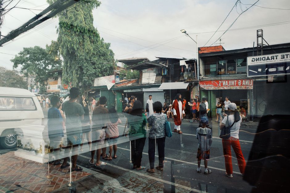 blurred crowd gathering outside local business storefront daytime