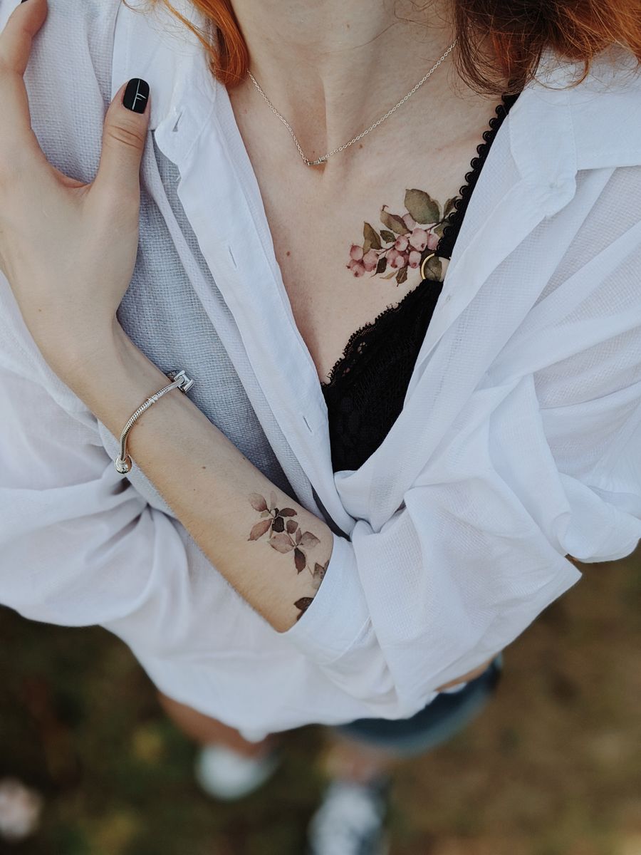 Floral ink flowing over arm and chest