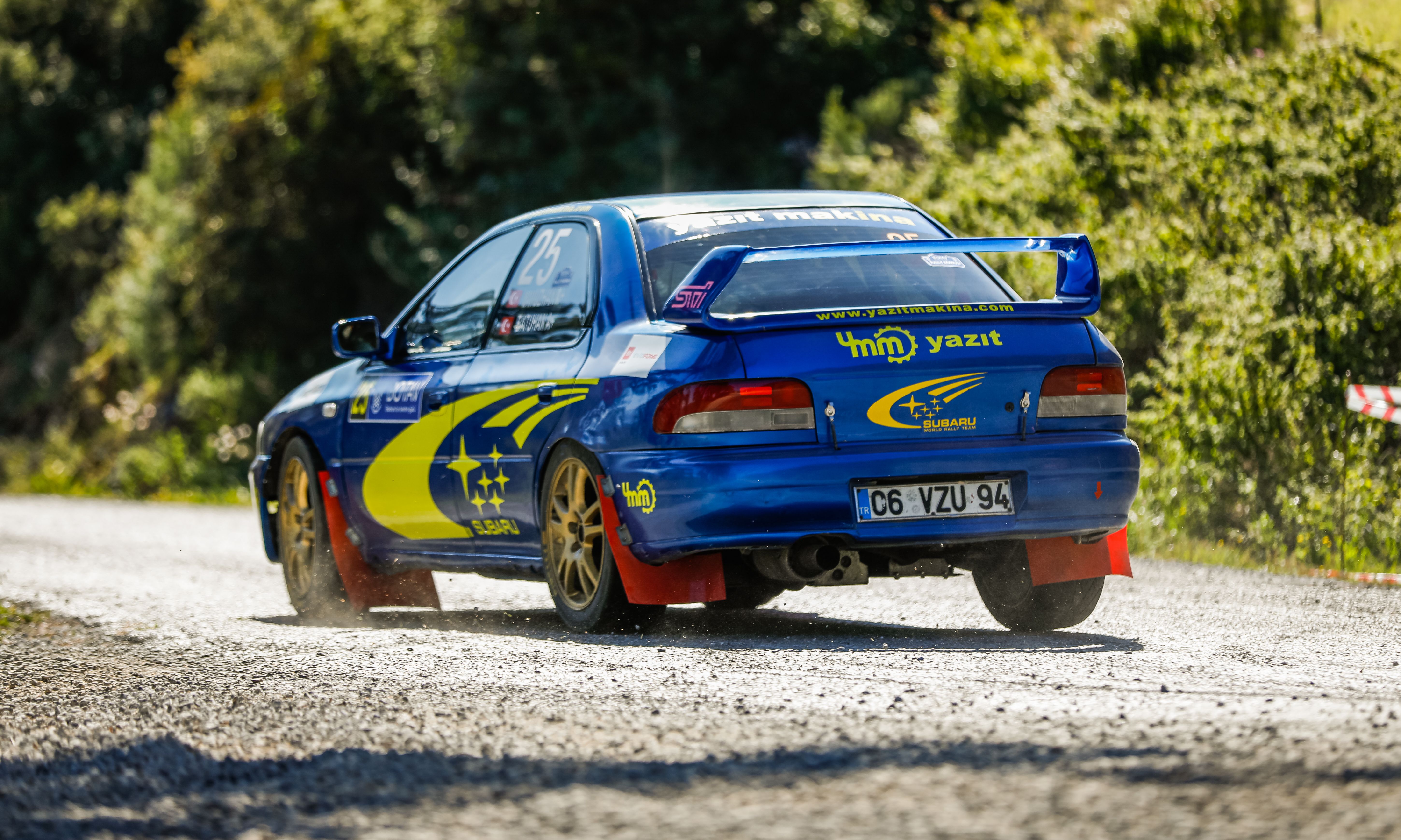 Dynamic Blue Rally Car Racing on Gravel Road · Free Stock Photo