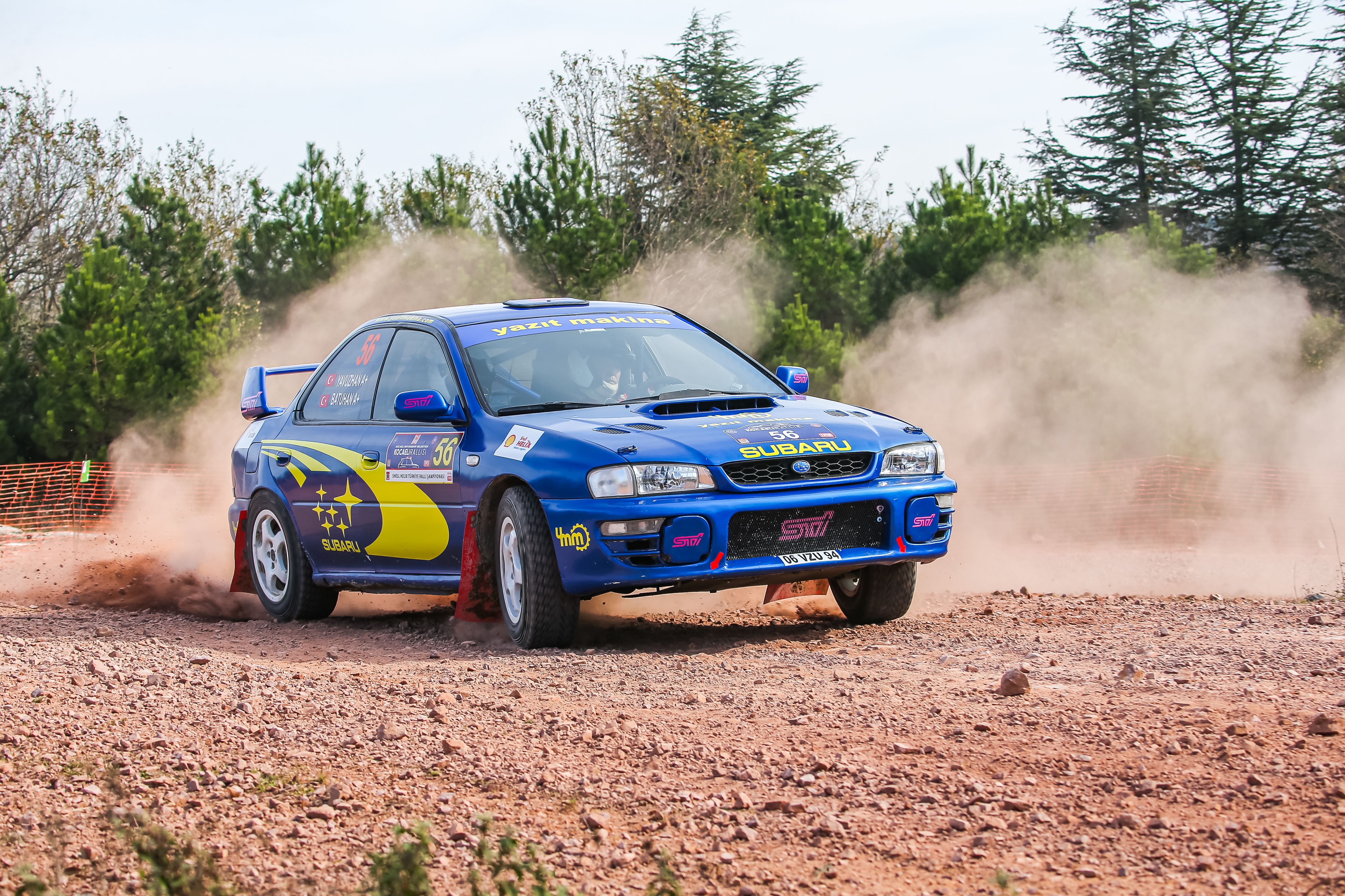 Blue Rally Car Drifting on Dirt Track Outdoors · Free Stock Photo