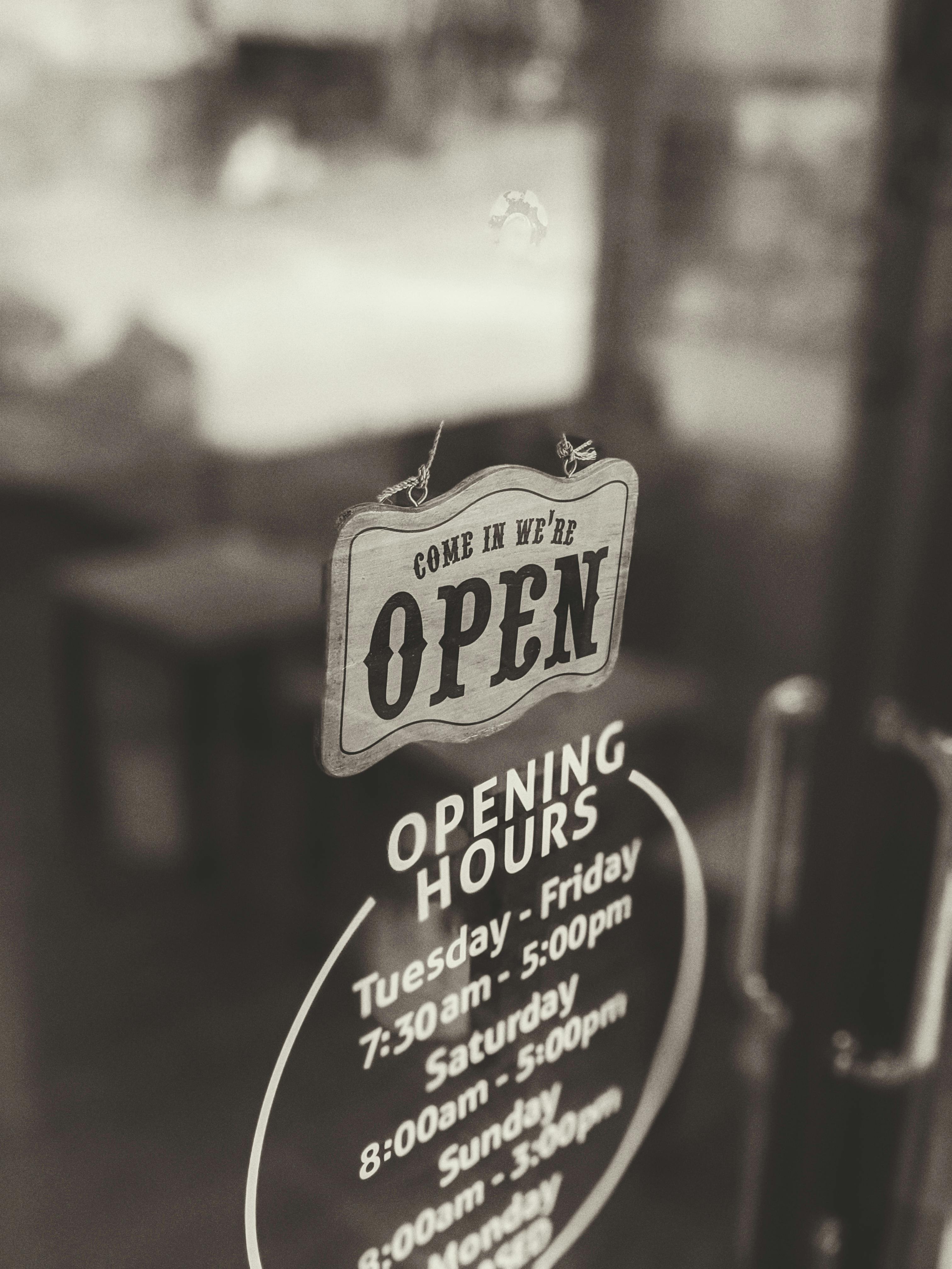 an open sign hanging on the door of a business establishment