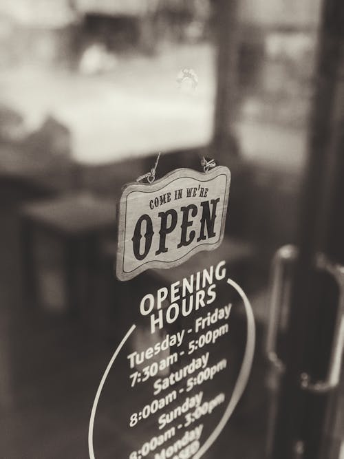 Free An Open Sign Hanging On The Door Of A Business Establishment Stock Photo