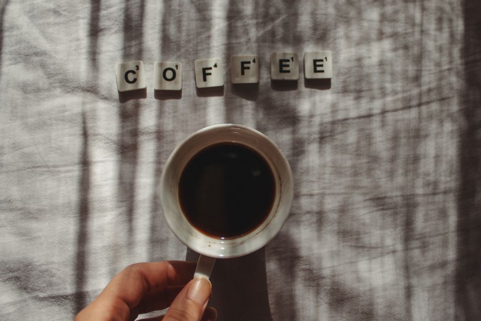 Patreon vs Buy Me a Coffee vs Ko-fi: Membership Features Compared (2024) Artistic coffee cup scene with scrabble letters spelling coffee. Perfect for beverage lovers.