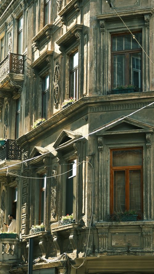 Free A classic European building with ornate architectural details and balconies under daylight. Stock Photo
