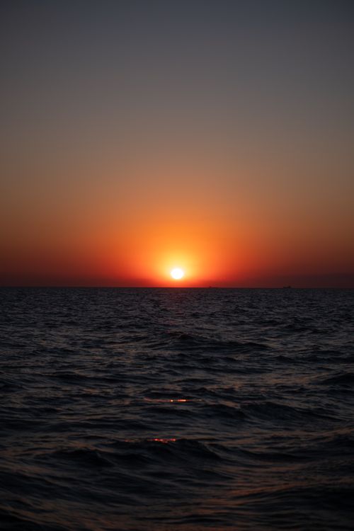 Free Beautiful sunset view over the Bosphorus with a vibrant sky blending orange and dark blue hues. Stock Photo