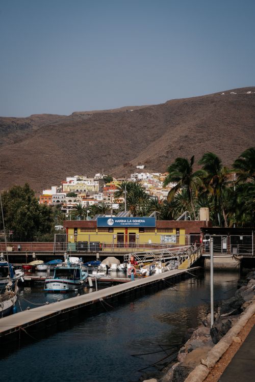 Free Colorful coastal village harbor in La Gomera, ideal for summer travel destinations. Stock Photo