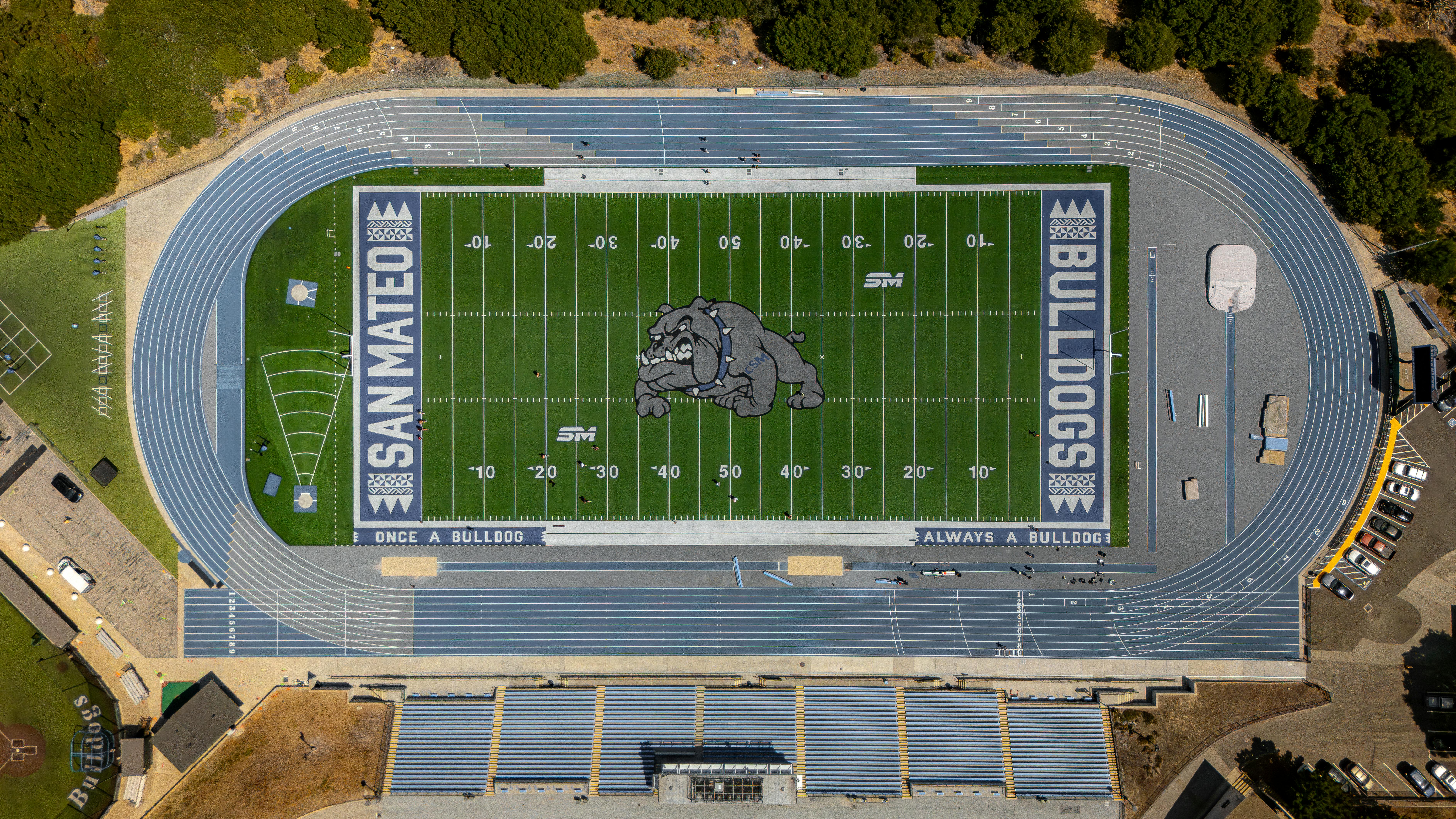 Aerial shot of San Mateo high school football field and track with bulldog logo and track lanes.