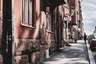 Explore a quaint Helsinki street featuring a boutique and classic architecture.