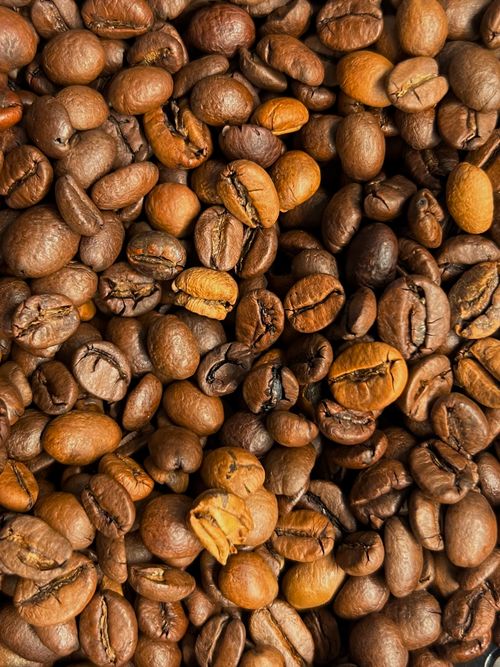 Free Detailed view of roasted coffee beans, ideal for backgrounds and textures, showcasing rich brown tones. Stock Photo