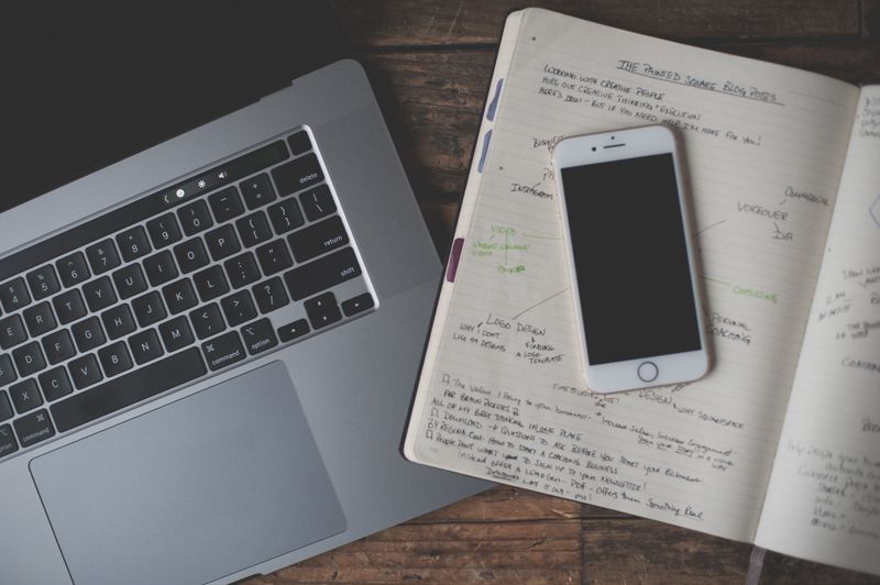 open notebook with handwritten to-do list and pen