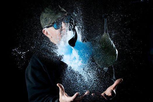 Dynamic capture of a water balloon bursting, caught mid-explosion with splashing water.