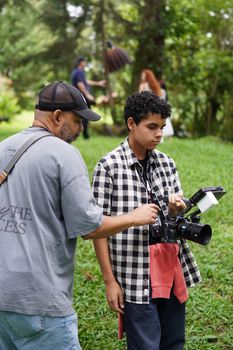 Adults engaged in a photography workshop in Costa Rica, teaching camera skills.