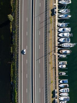 Aerial shot of a highway with cars beside a marina in Huskvarna, Sweden.
