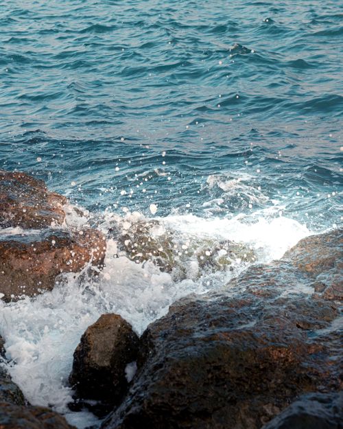 Free Peaceful seascape of waves crashing on rocky shore in Karataş, Türkiye. Perfect for nature and travel themes. Stock Photo