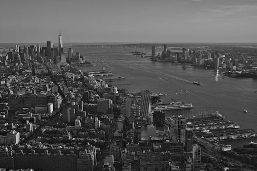 Stunning black and white aerial view of New York City skyline with Hudson River.