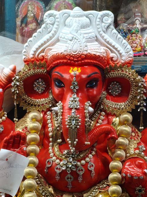 Free A richly decorated red Ganesh idol adorned with jewels, perfect for festivals and spiritual decor. Stock Photo