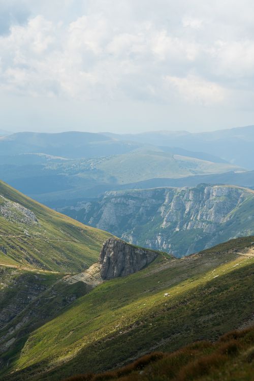 Free Breathtaking view of the lush green mountains of Piatra Craiului, Romania. Stock Photo