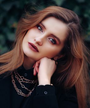Stunning portrait of a woman with red hair, exuding elegance and beauty.
