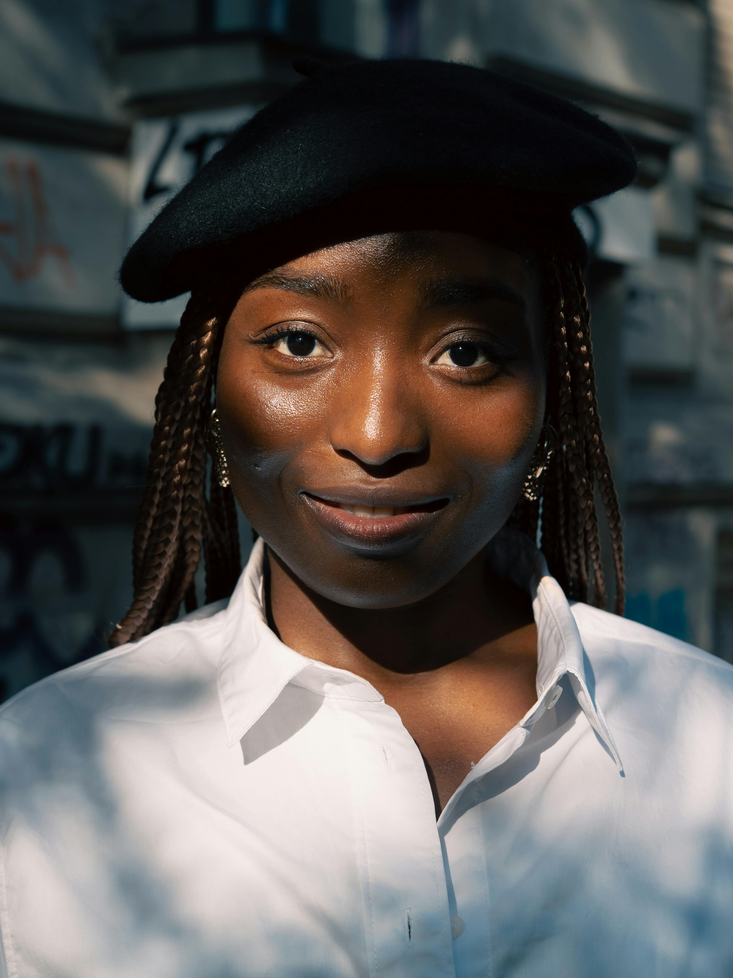 A stylish portrait of a woman in Berlin wearing a beret and braided hairstyle, capturing modern fashion and cultural expression.