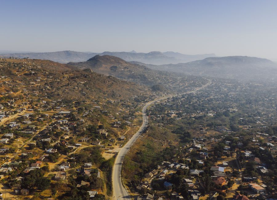 Aerial photograph capturing expansive rural landscape near eSwatini border, showcasing winding road through hills.