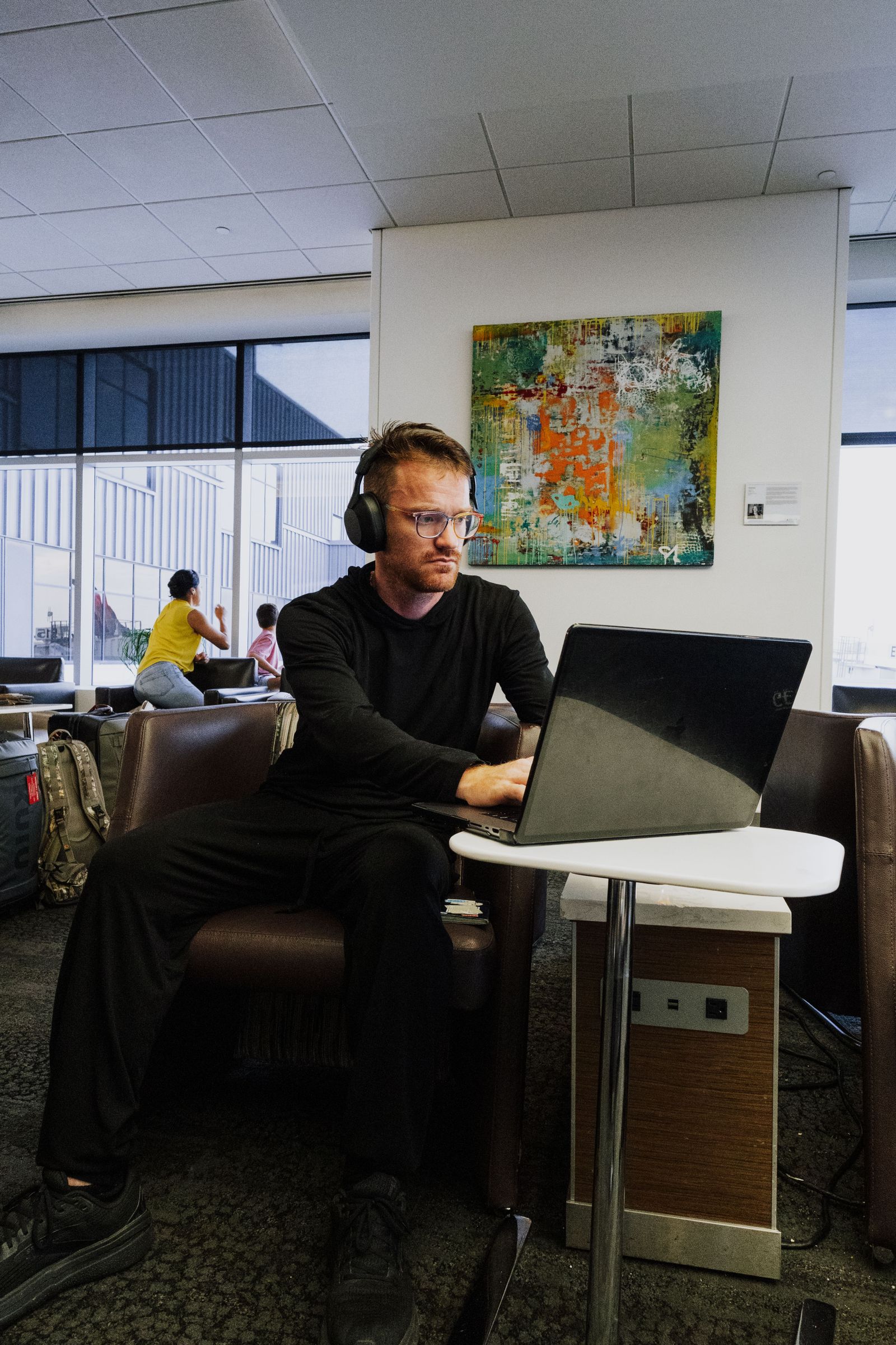 Business traveler working with connected devices in an airport lounge