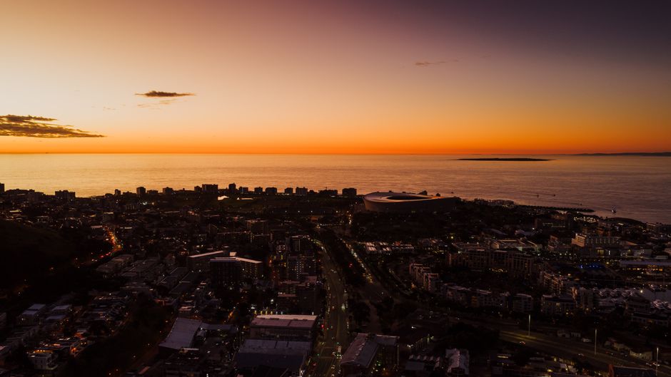 Best Scenic Cape Point Helicopter Tour from Cape Town Review Review 2026 - Stunning aerial view of Cape Town cityscape during sunset with ocean horizon in the background.