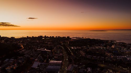 Free Stunning aerial view of Cape Town cityscape during sunset with ocean horizon in the background. Stock Photo