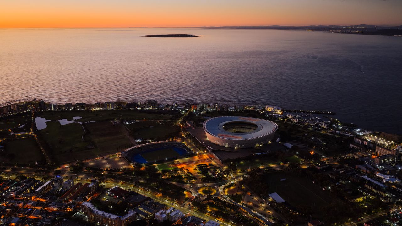 stunning aerial view of cape town stadium and coastline during sunset