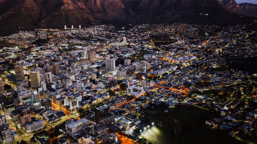 Aerial night view of Cape Town beneath Table Mountain, South Africa
