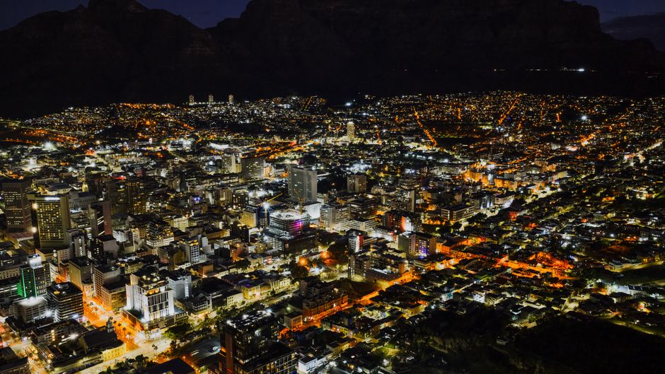 Amazing Two Oceans Helicopter Tour in Cape Town Review: Soaring Above Africa's Most Stunning Peninsula Review 2026 - Stunning aerial night view of Cape Town cityscape, showcasing illuminated buildings and streets.