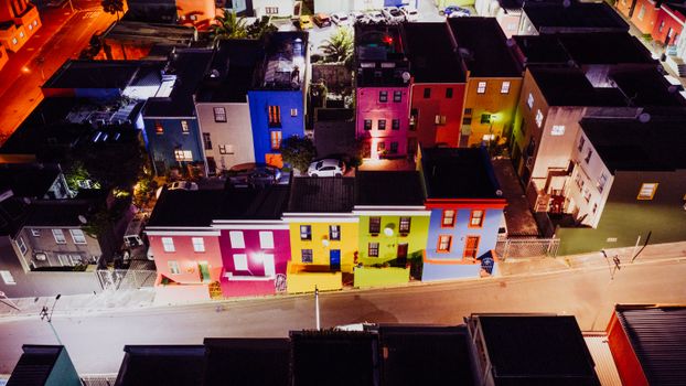 Aerial view of Bo-Kaap's colorful houses in Cape Town, South Africa, illuminated at night.