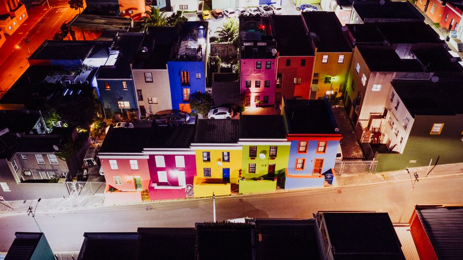 Aerial view of Bo-Kaap's colorful houses in Cape Town, South Africa, illuminated at night.