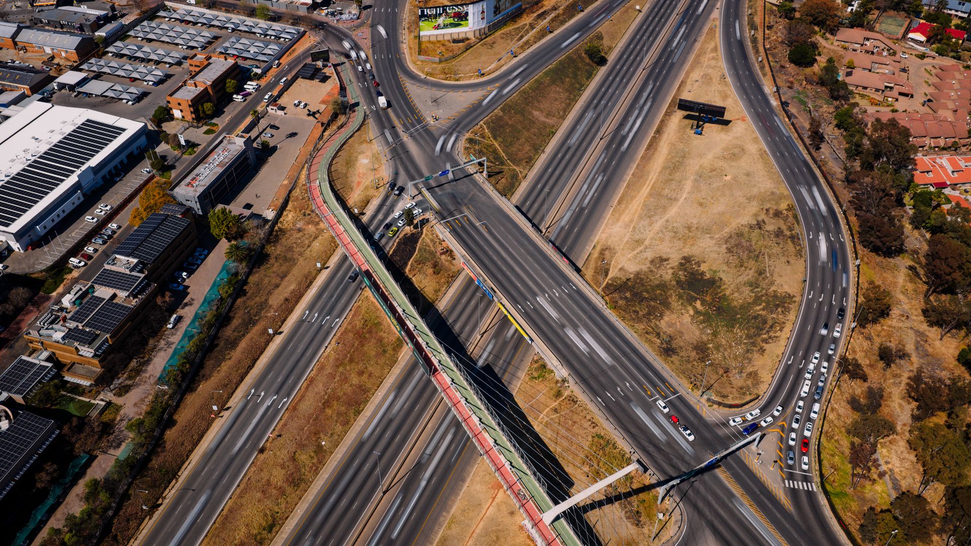 Aerial view of a busy highway interchange with flowing traffic