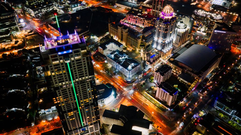Spectacular Day Flight 23 Miles HeliCoaster Adventure Ride Review: Orlando's Most Thrilling Helicopter Experience Review 2026 - A stunning aerial view of Sandton, Gauteng, South Africa lit up at night, showcasing modern architecture and vibrant city lights.