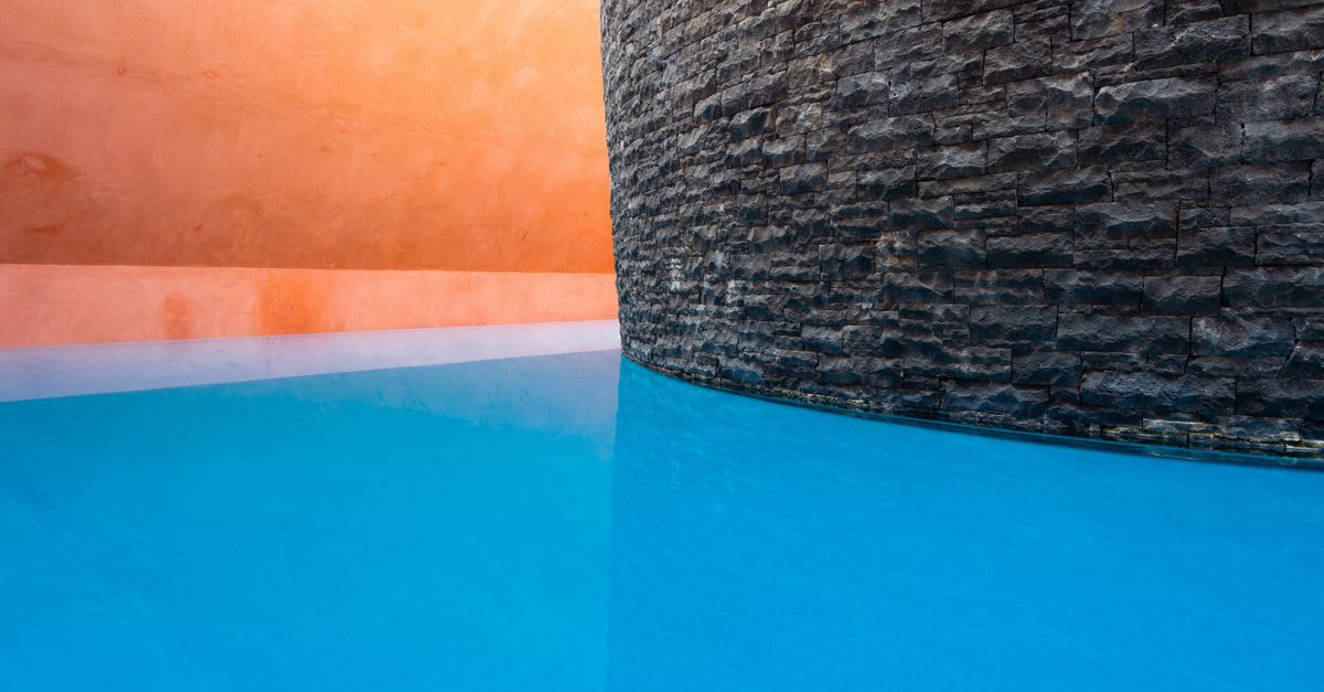 Modern architectural design with vibrant colors and reflective water in Canberra, Australia.