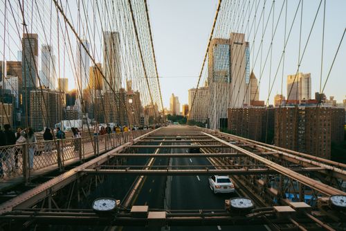 Free View of Brooklyn Bridge with Manhattan skyline at sunset, capturing urban life and architecture. Stock Photo