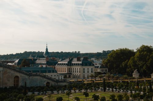 Free A picturesque view of Versailles' classical architecture and gardens in Île-de-France, France. Stock Photo