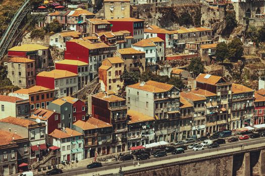 A vibrant aerial view of colorful hillside houses in Porto, Portugal, showcasing traditional architecture.
