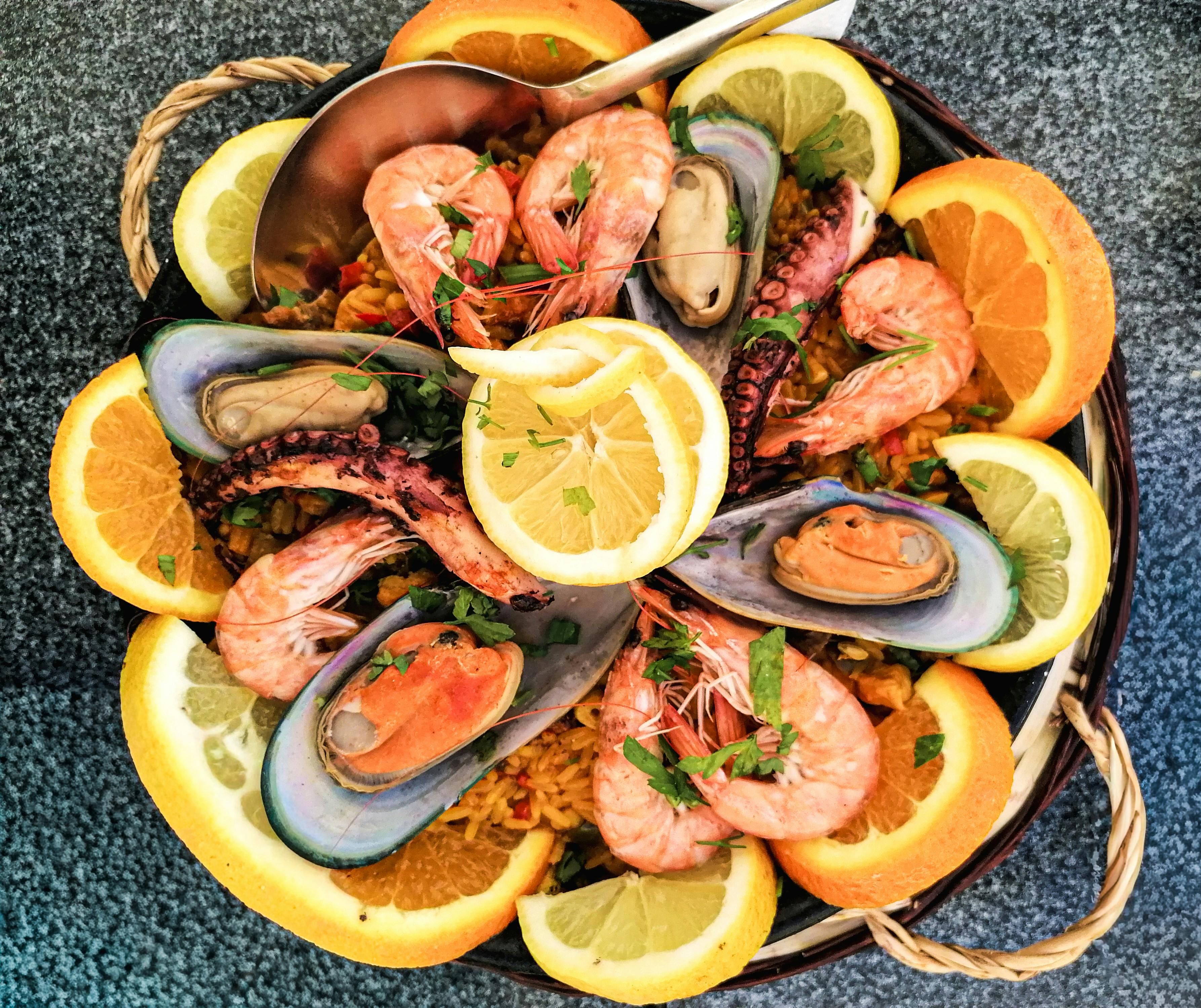 A variety of different types of rice grains displayed on a wooden table.