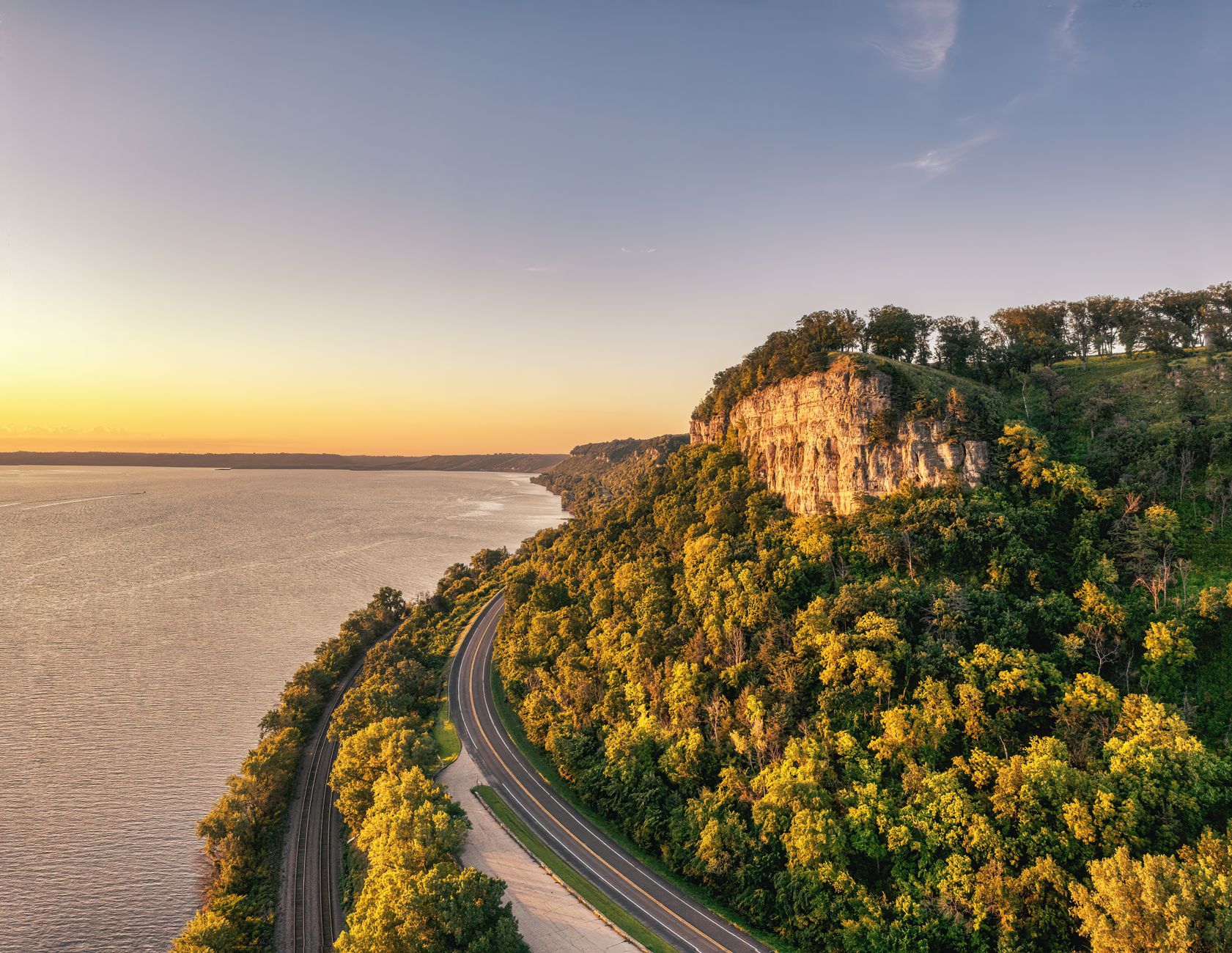 A breathtaking view of Stockholm, Wisconsin's Mississippi River bluffs at sunset, highlighting the natural beauty of the landscape.