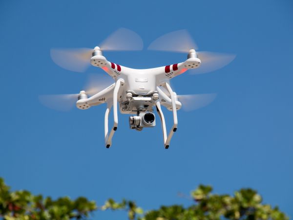 Survey drone flying against a blue sky