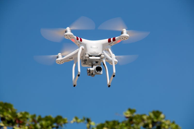 Drone flying against vibrant blue sky ready for aerial photography adventure