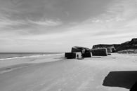 World War II bunkers on a tranquil Danish beach in black and white.