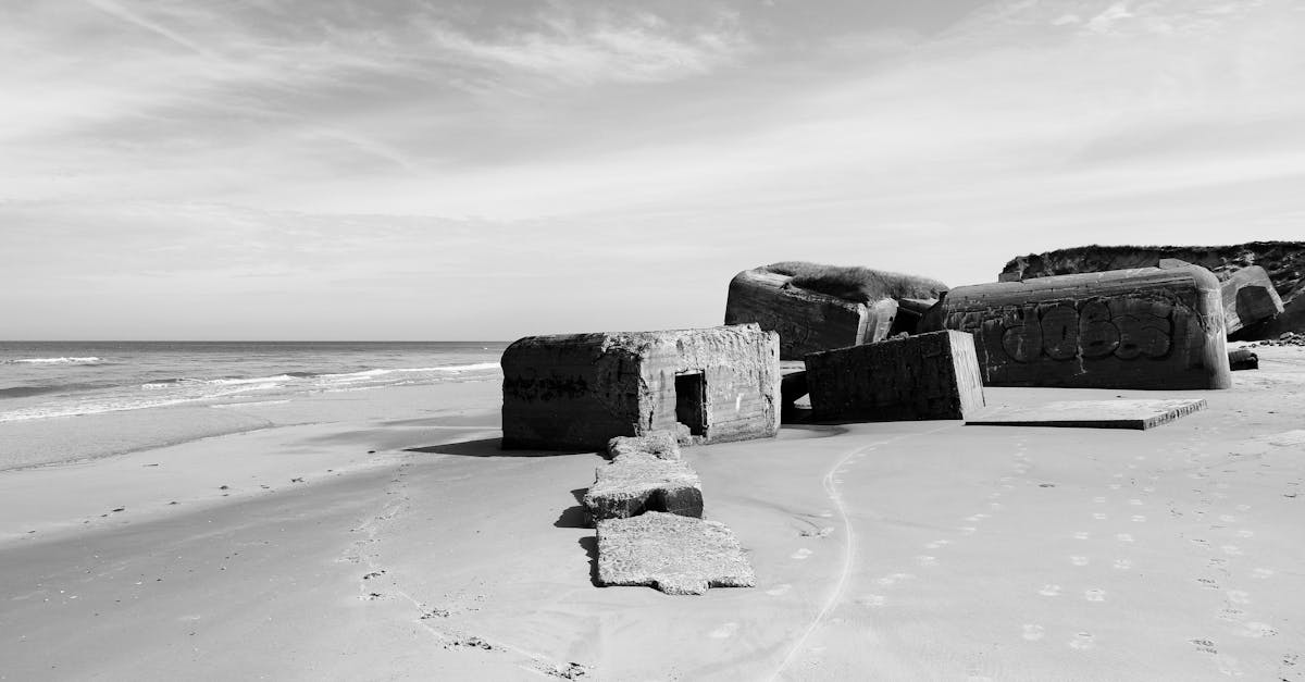 Monochrome view of a World War II bunker on a deserted Danish beach.