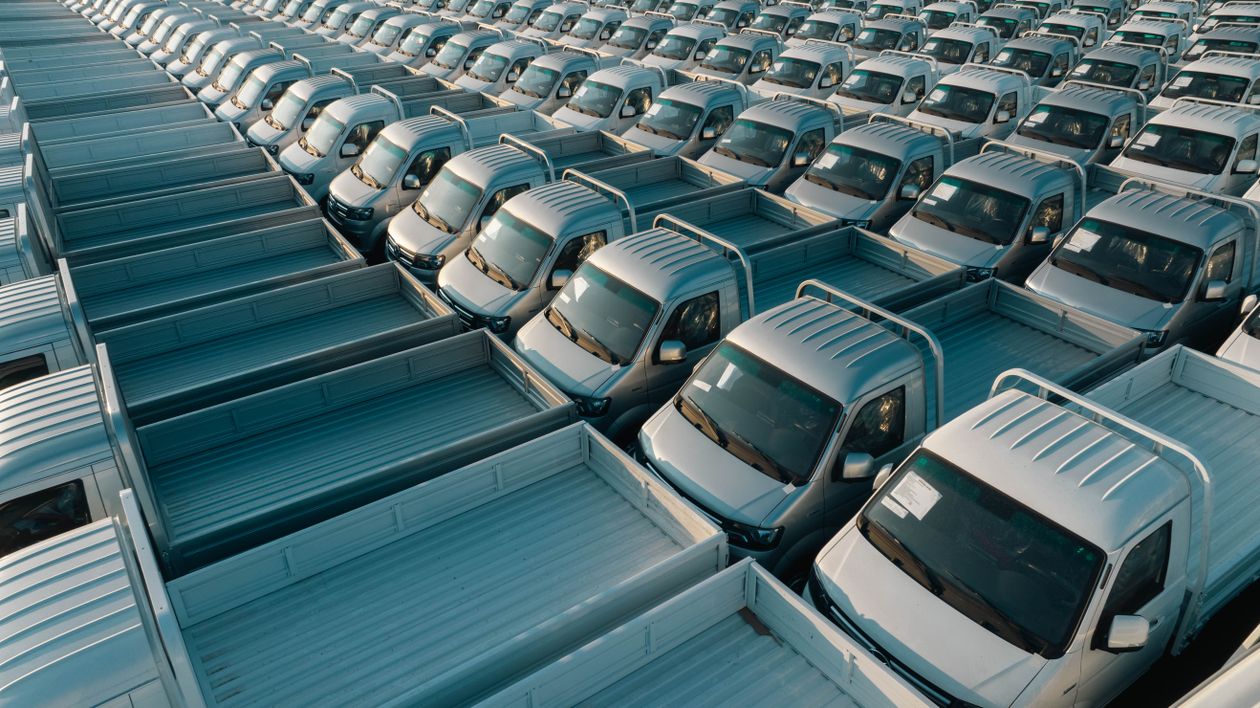 Aerial view of rows of vehicles at a dealer inventory lot ready for bulk transport