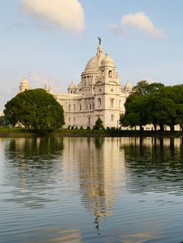 Majestic view of Victoria Memorial with its reflection on a serene lake in Kolkata, India.