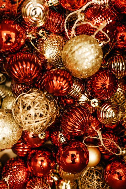 A vibrant collection of red and gold Christmas ornaments for holiday decoration.